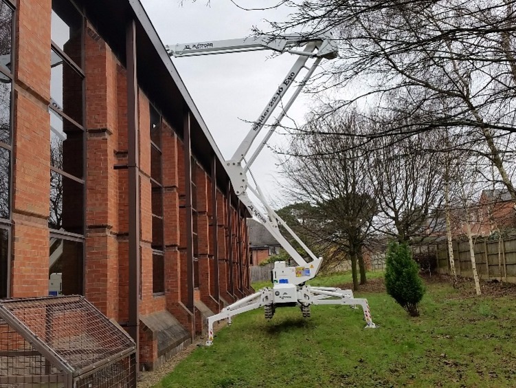 Selina tracked spiderlift cherrypickers for building inspection and maintenance from High Reaching Solutions setting up on uneven soft ground Richmond York North Yorkshire